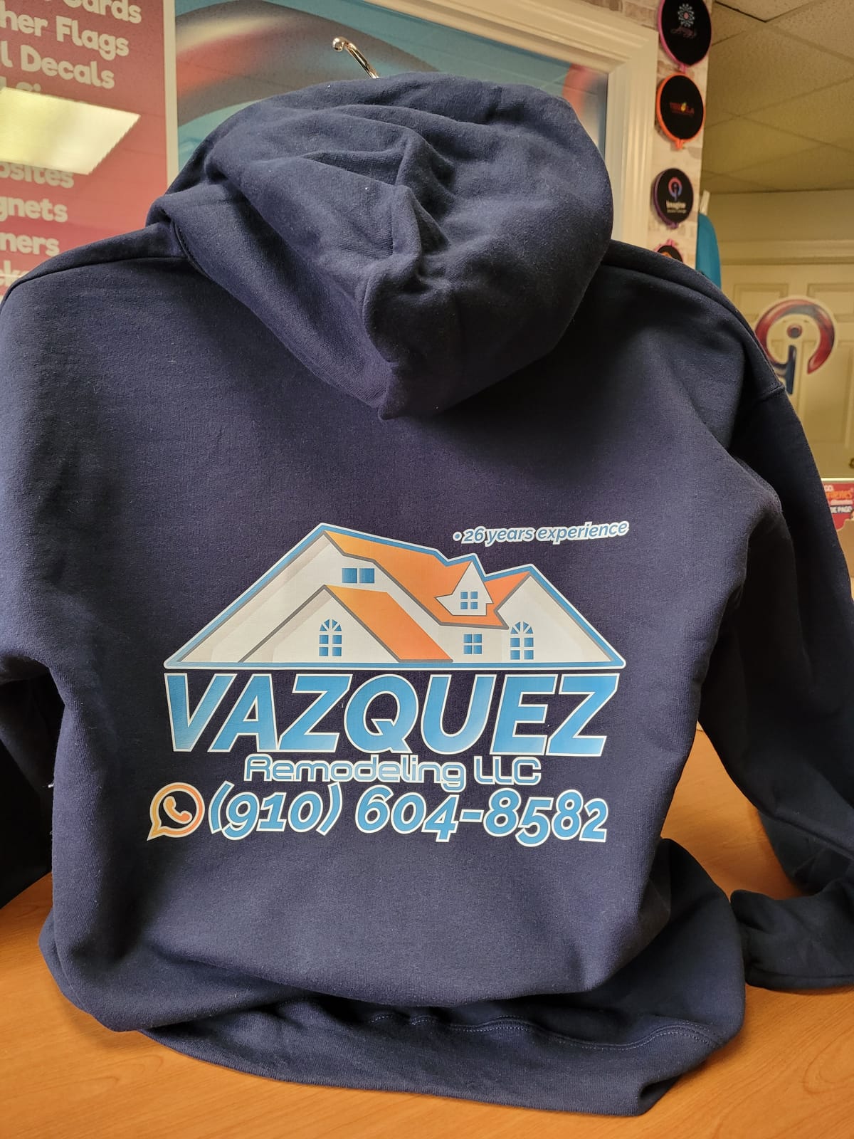 Navy hoodie branded for Vazquez Remodeling LLC